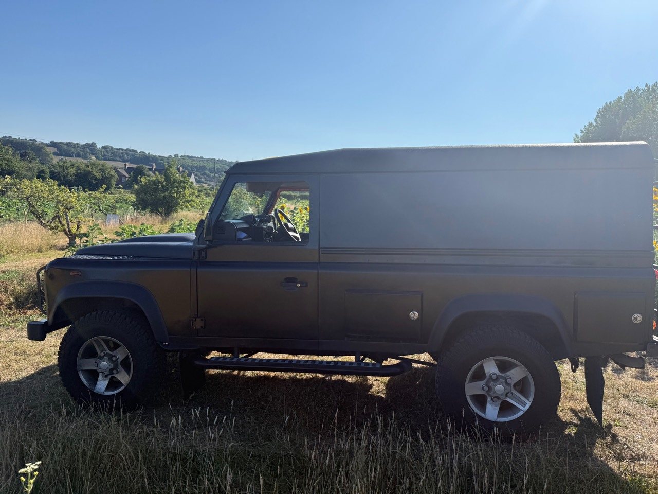 Full driver-side view of the black Defender hard top