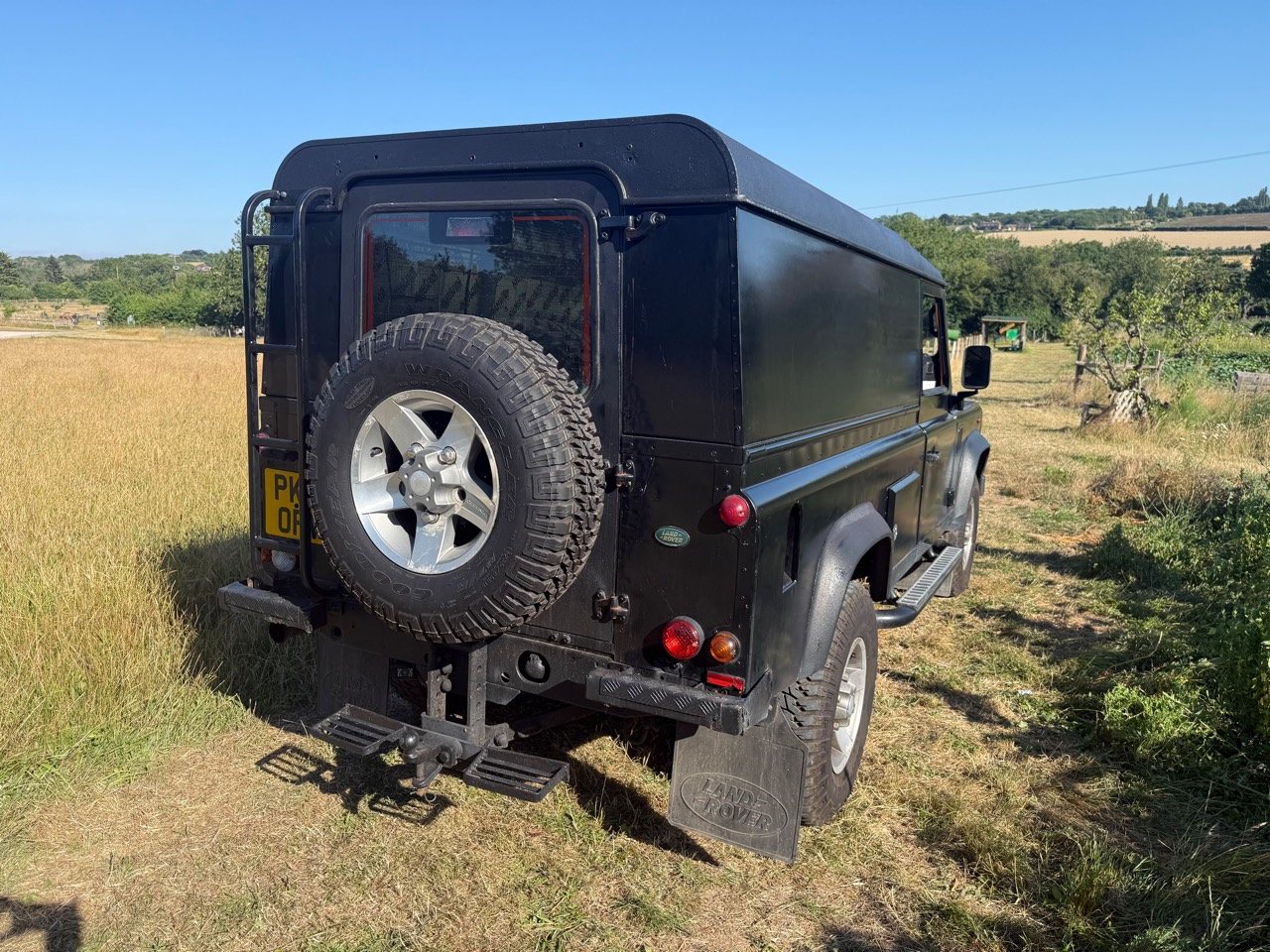 Rear three-quarter view showing the spare wheel and passenger side