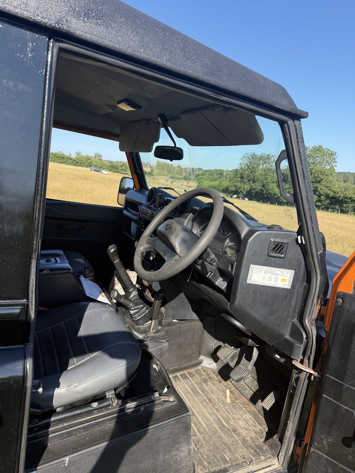 Driver's cab showing the seats, steering wheel and six-speed manual gearbox