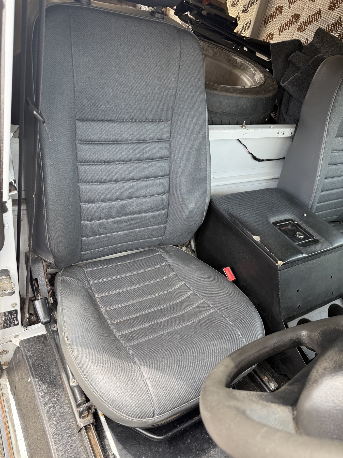 Close view of the Defender's two front seats and centre cubby
