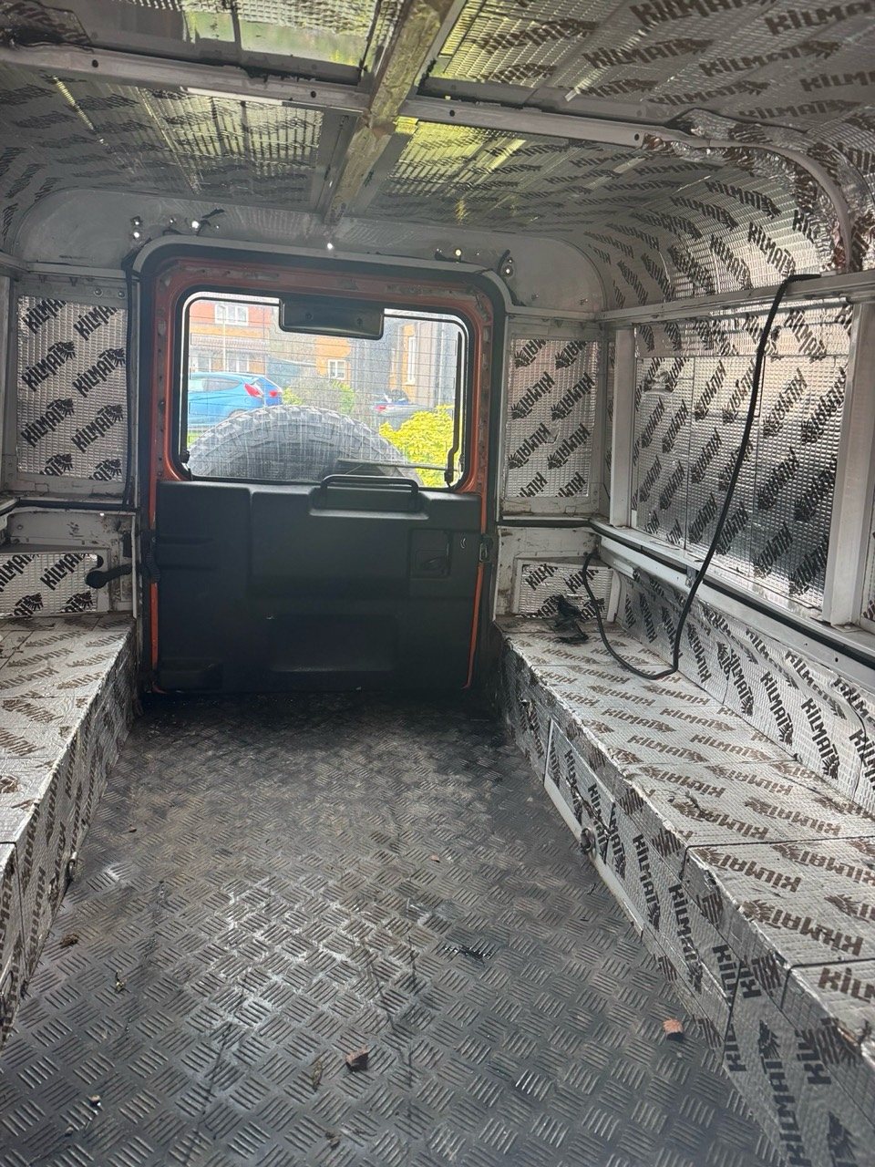 Empty rear load area with chequer-plate floor and foil sound-deadening